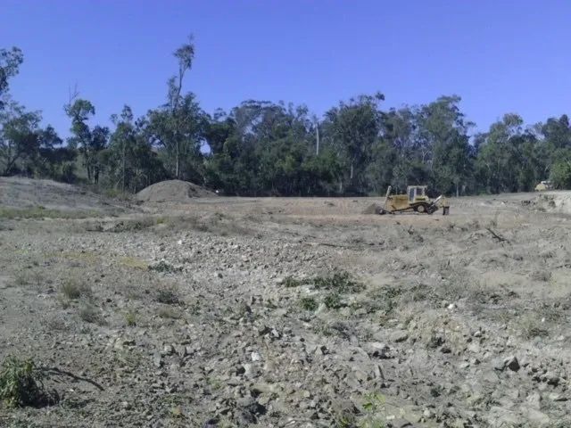 Excavator Cleaning The Field — Mike Barlow Earthmoving Pty Ltd in Rockhampton, QLD