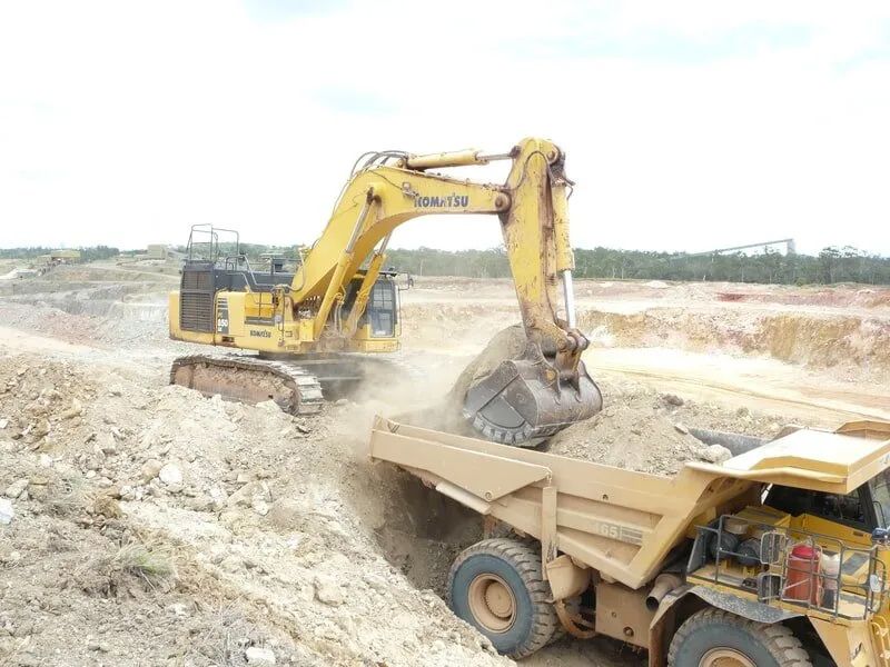 Excavator Loading Rock In The Dump Truck — Mike Barlow Earthmoving Pty Ltd in Rockhampton, QLD