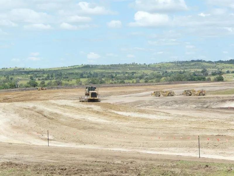 An Excavator Working In The Dirt Field — Mike Barlow Earthmoving Pty Ltd in Rockhampton, QLD