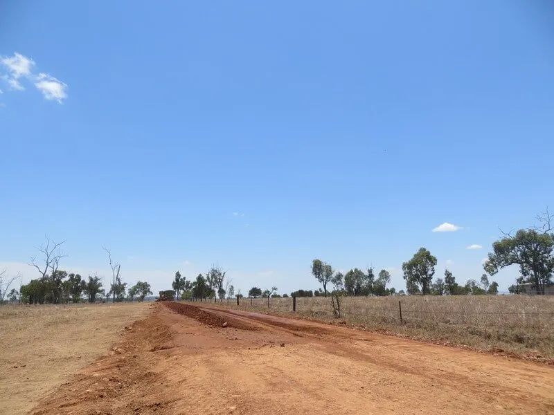 Wide View Of A Dirt Road With Sky In Background — Mike Barlow Earthmoving Pty Ltd in Rockhampton, QLD