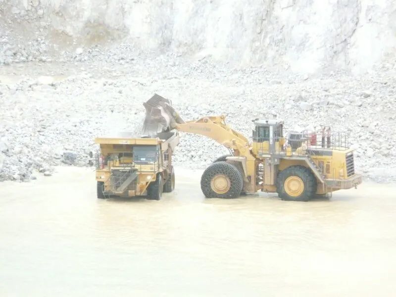 Excavator Loading Rocks on a Truck — Mike Barlow Earthmoving Pty Ltd in Rockhampton, QLD