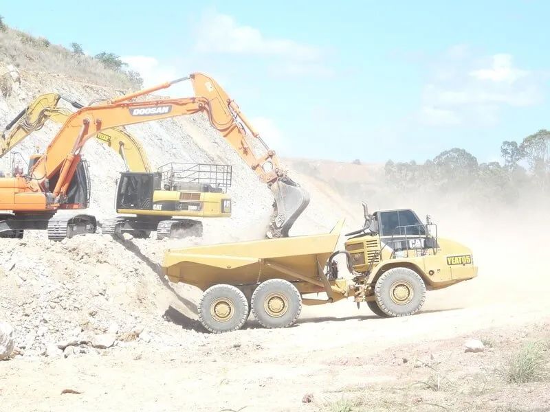 Excavator And Dump Truck In A Site — Mike Barlow Earthmoving Pty Ltd in Rockhampton, QLD