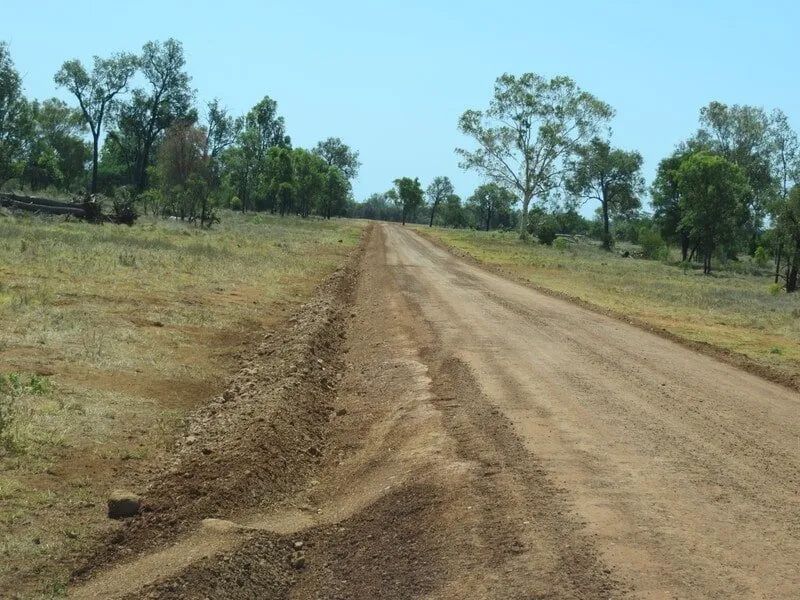 Dirt Road With Trees and Sky In Background — Mike Barlow Earthmoving Pty Ltd in Rockhampton, QLD