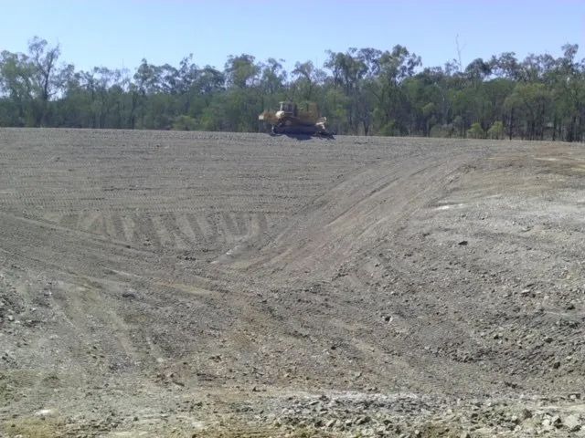 Bulldozer Parked On A Dam Construction Area — Mike Barlow Earthmoving Pty Ltd in Rockhampton, QLD