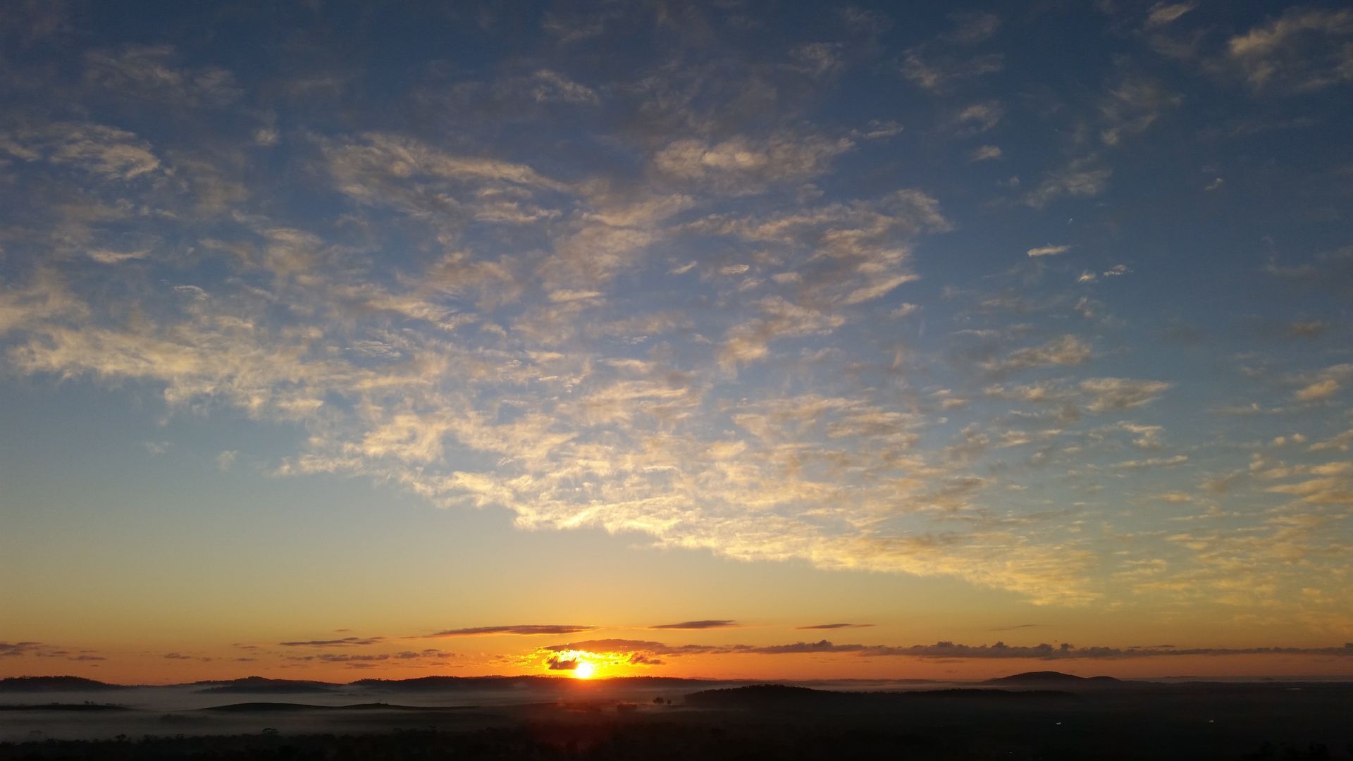 A White Truck Is Taking Turn On The Side of A Dirt Road — Mike Barlow Earthmoving Pty Ltd in Rockhampton, QLD