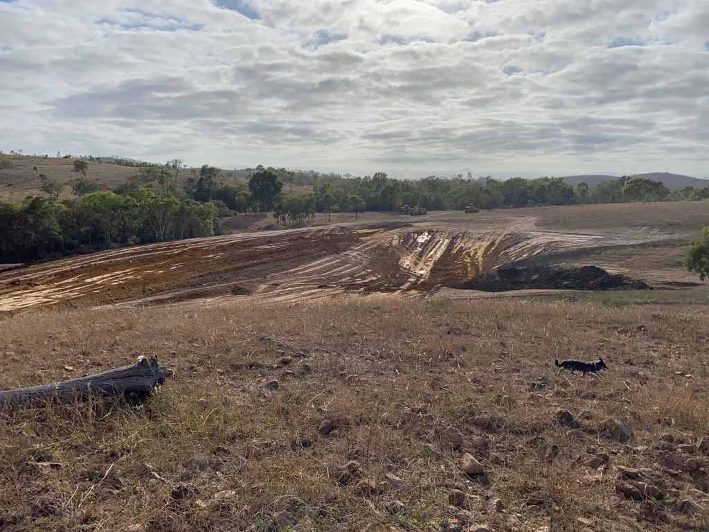 Dam Is Being Constructed Besides A Road — Mike Barlow Earthmoving Pty Ltd in Rockhampton, QLD