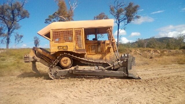 An Excavator Is Loading Soil Into a Dump Truck — Mike Barlow Earthmoving Pty Ltd in Rockhampton, QLD