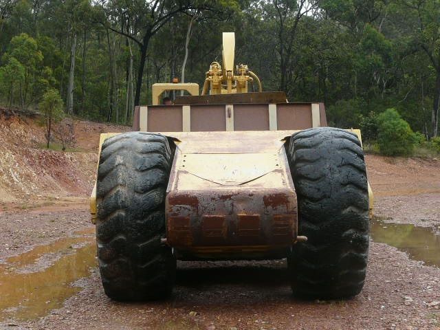 A Group of Construction Vehicles Are Working on A Dam — Mike Barlow Earthmoving Pty Ltd in Rockhampton, QLD