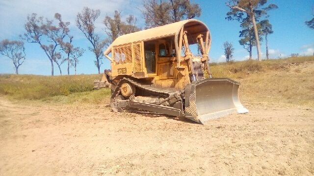 A Bulldozer is Loading a Gravel In A Dump Truck — Mike Barlow Earthmoving Pty Ltd in Rockhampton, QLD