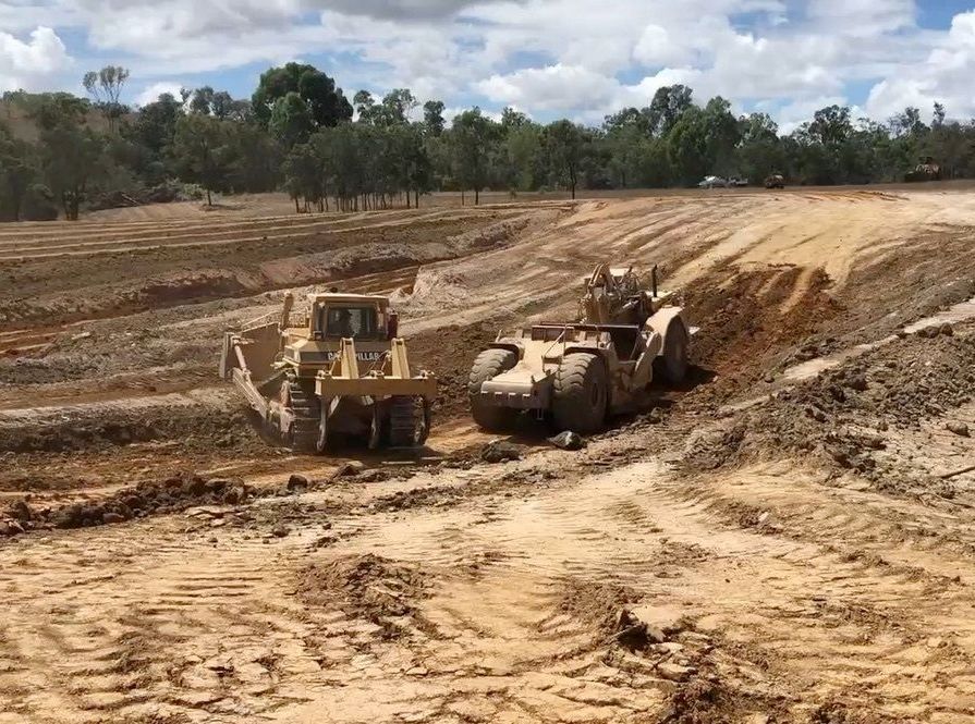 Bulldozers Working On Dirt Area For Dam Construction — Mike Barlow Earthmoving Pty Ltd in Rockhampton, QLD