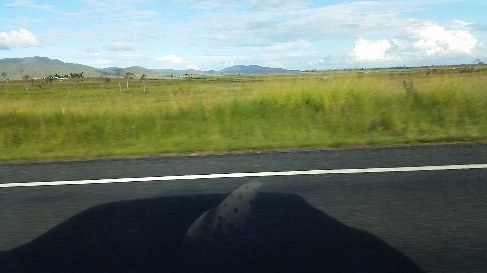 A Yellow Excavator Is Loading Dirt Into a Dump Truck — Mike Barlow Earthmoving Pty Ltd in Central Highlands, QLD