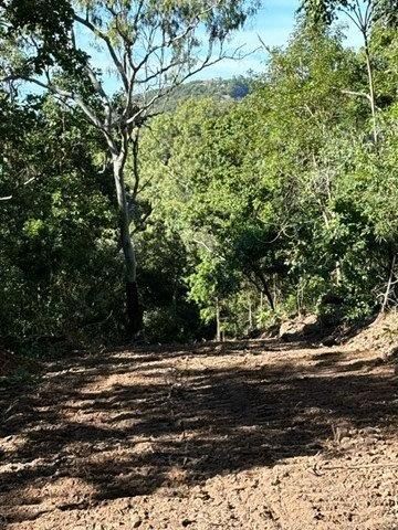 A Yellow Excavator Is Digging a Pile of Dirt on A Construction Site — Mike Barlow Earthmoving Pty Ltd in Rockhampton, QLD