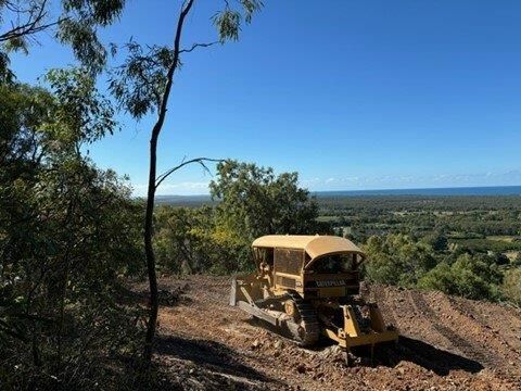 A Tractor Is Passing By A Property — Mike Barlow Earthmoving Pty Ltd in Rockhampton, QLD