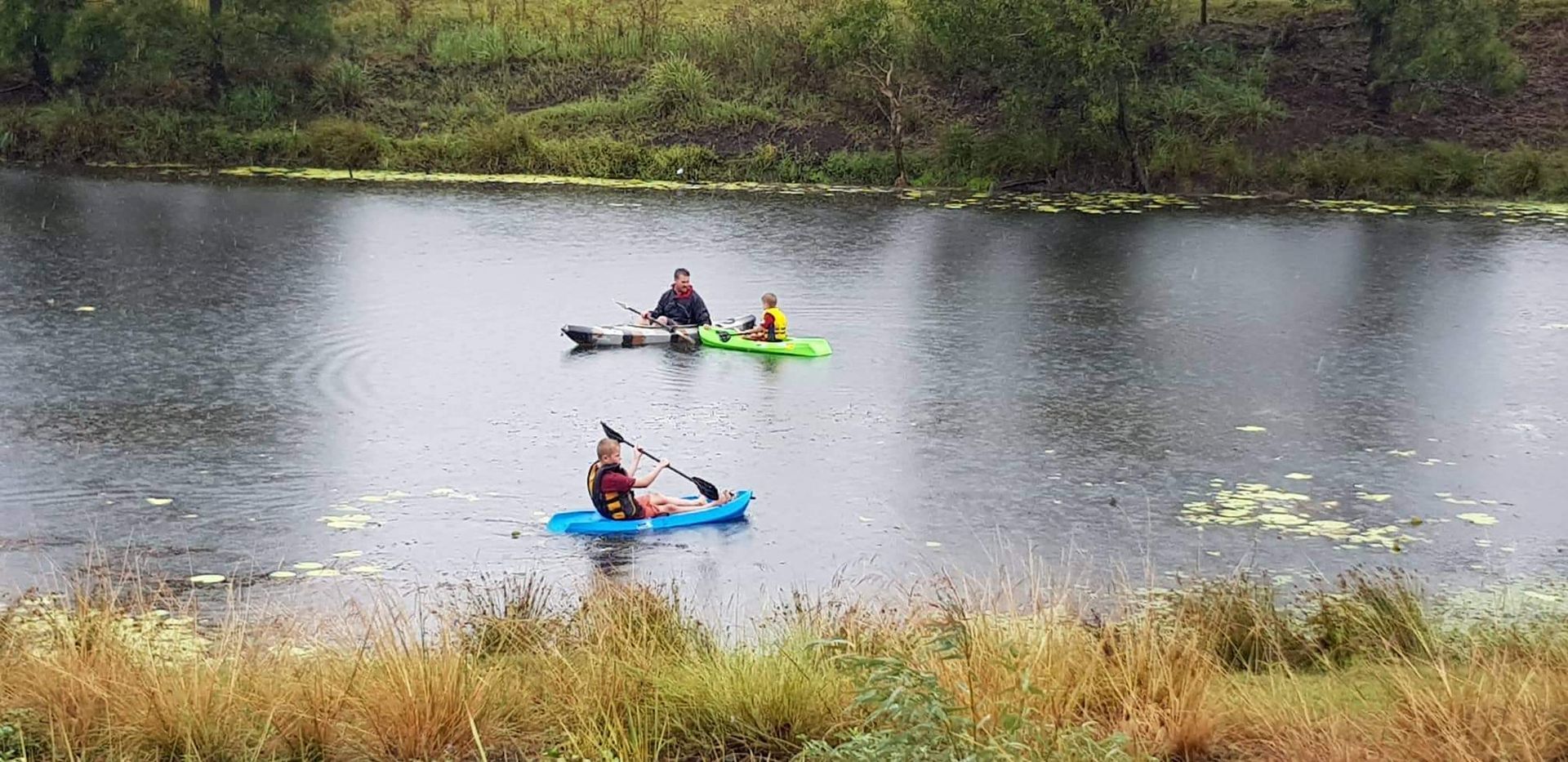 A Large Excavator Is Digging in The Dirt on A Construction Site — Mike Barlow Earthmoving Pty Ltd in Rockhampton, QLD