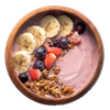 Acai bowl with banana slices, blueberries, strawberries, and granola in a wooden bowl.