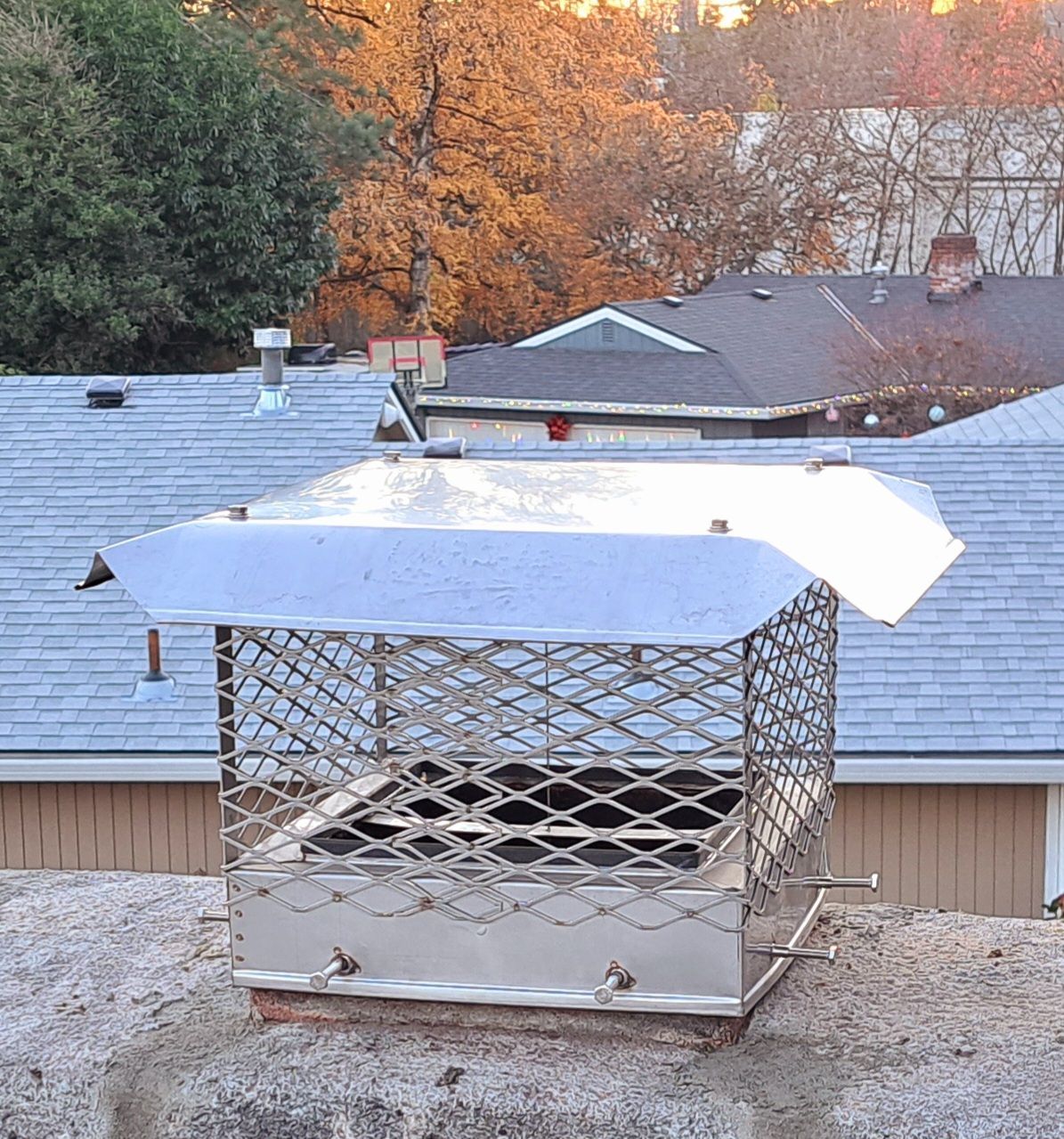 A chimney on top of a building with a roof in the background
