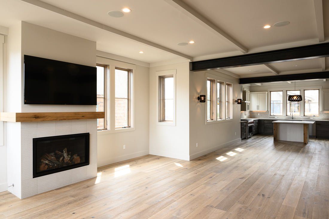 A living room with a fireplace and a flat screen tv.