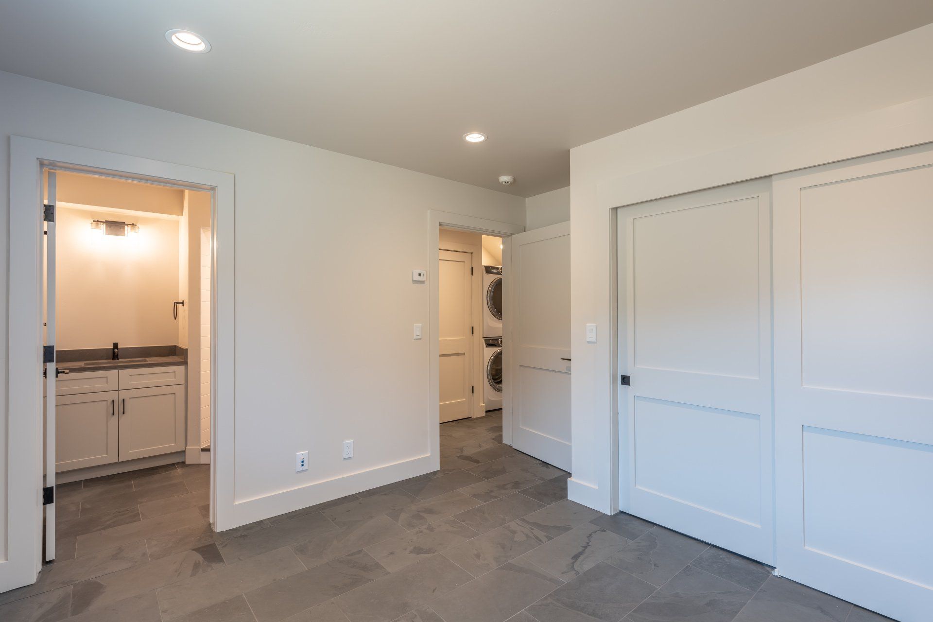 There is a laundry room with a washer and dryer in it.