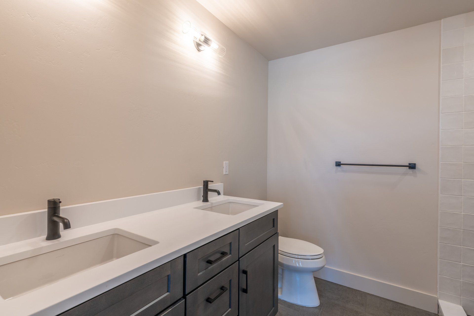 A bathroom with a sink , toilet and shower.