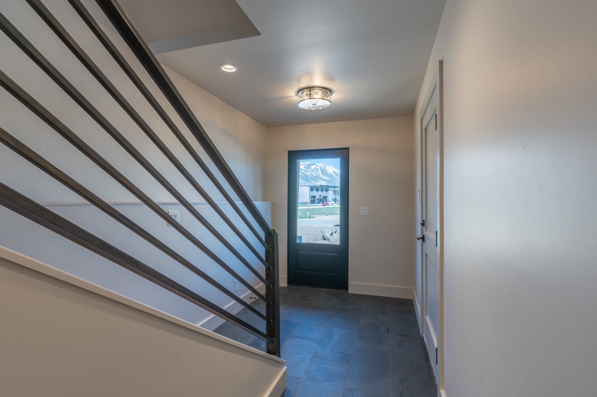 A hallway with stairs leading up to the second floor of a house.