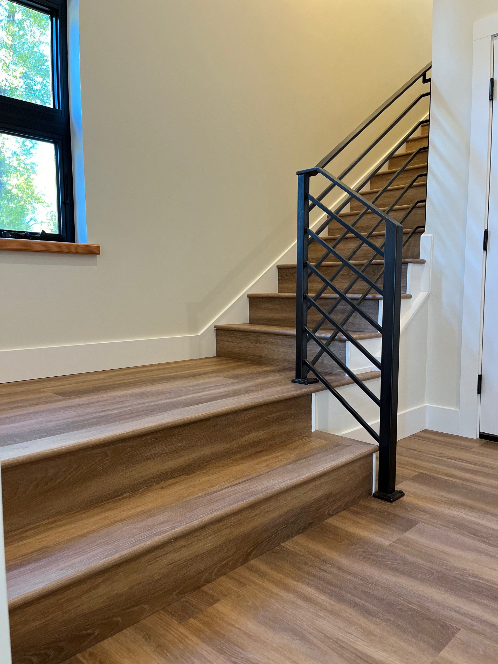 A staircase with wooden steps and a metal railing