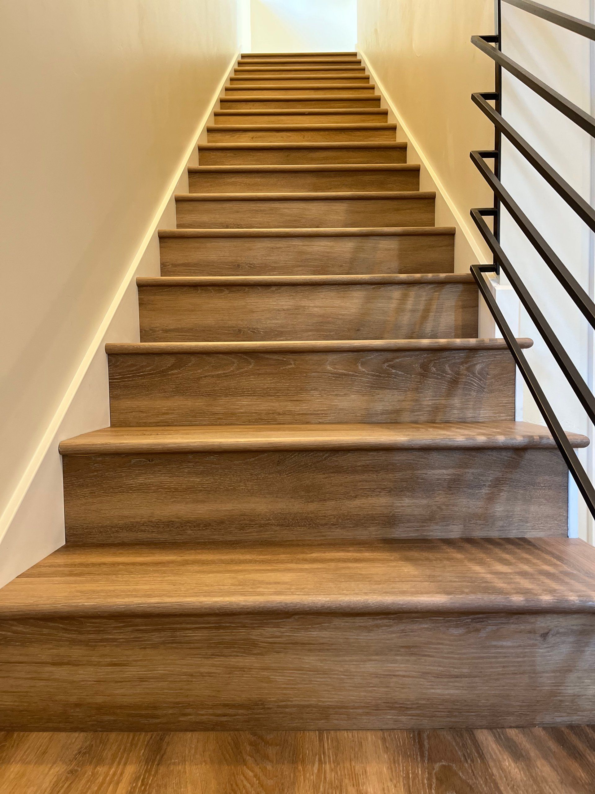 The stairs are made of wood and have a metal railing.