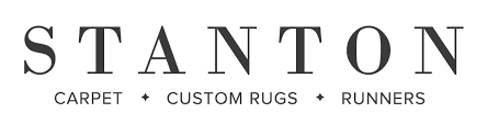 The logo for stanton carpet custom rugs and runners