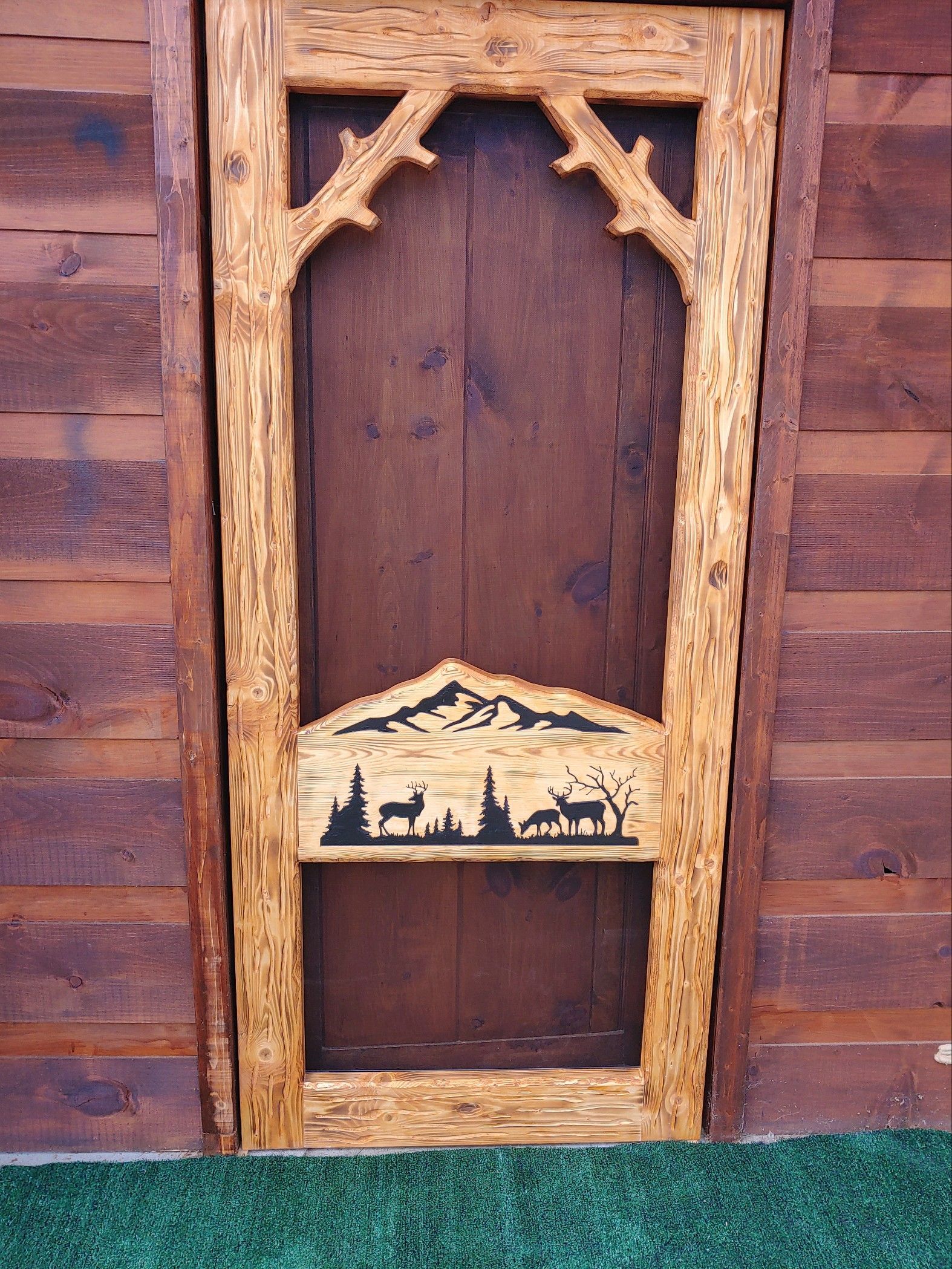 Rustic Screen Door with Carved Middle Rail Showing a Family of Deer