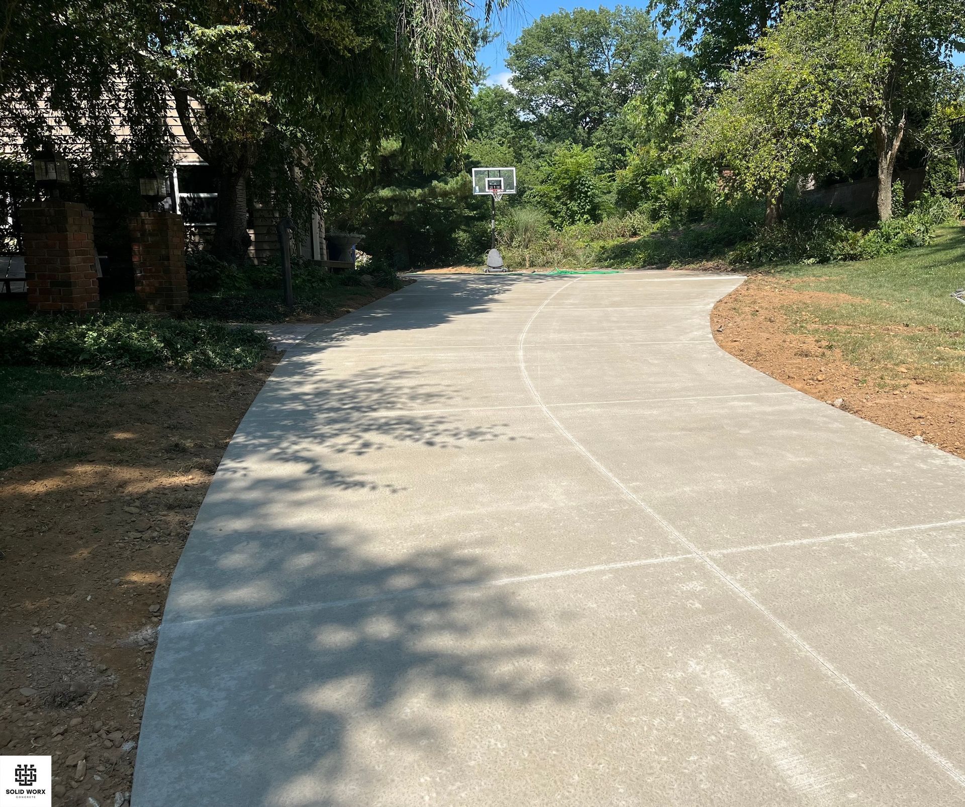 A concrete driveway is being built in front of a house.