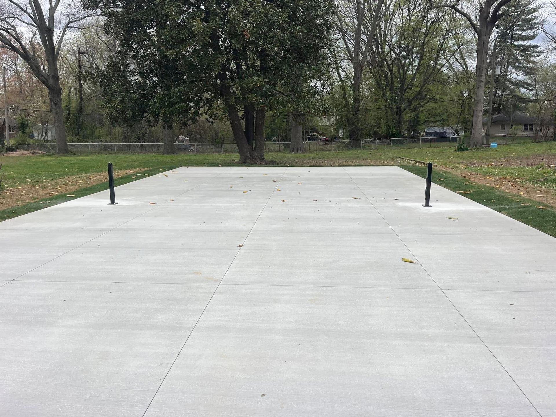 A concrete driveway is being built in front of a house.