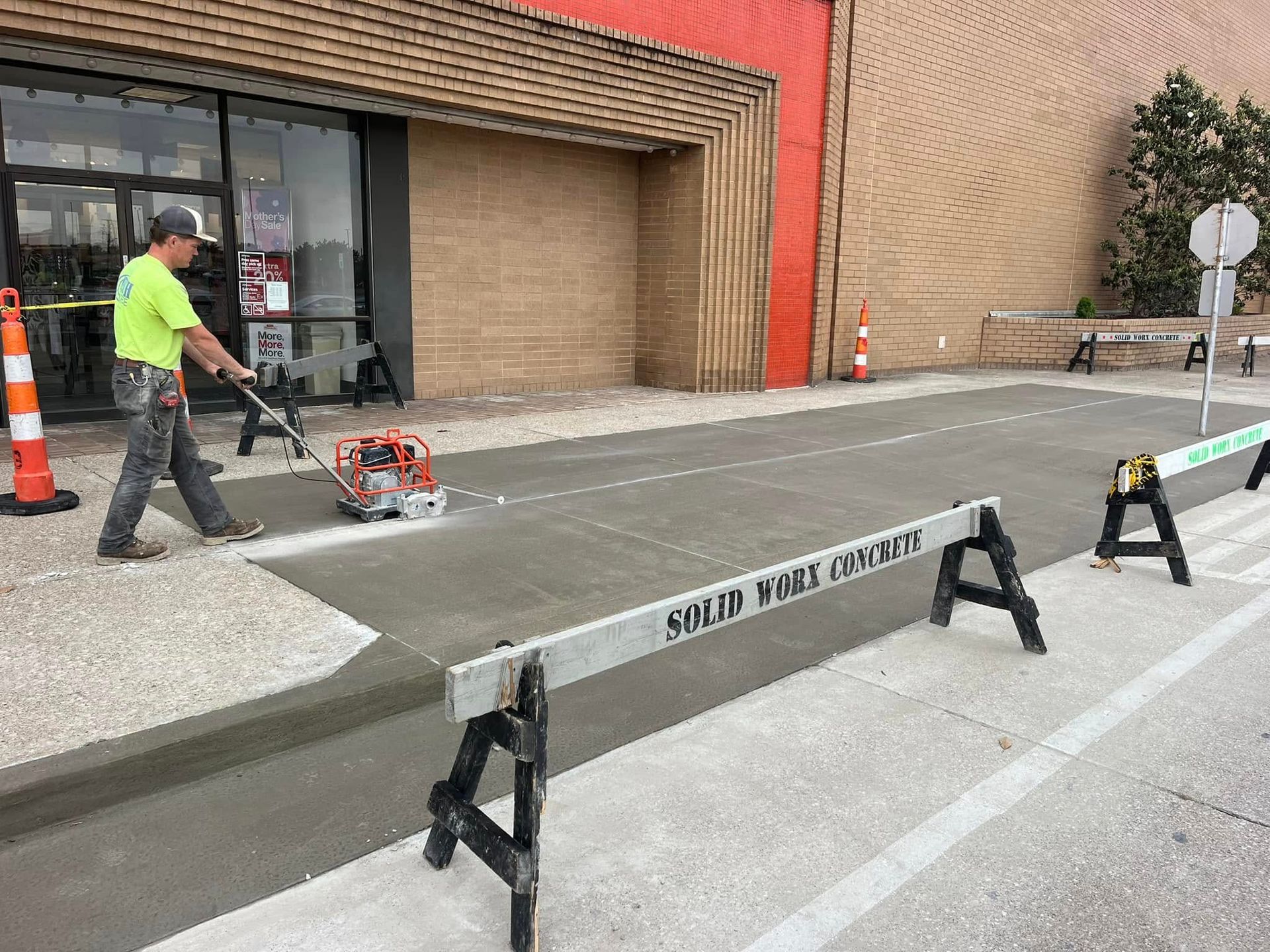 A large building with a lot of windows and a yellow curb.
