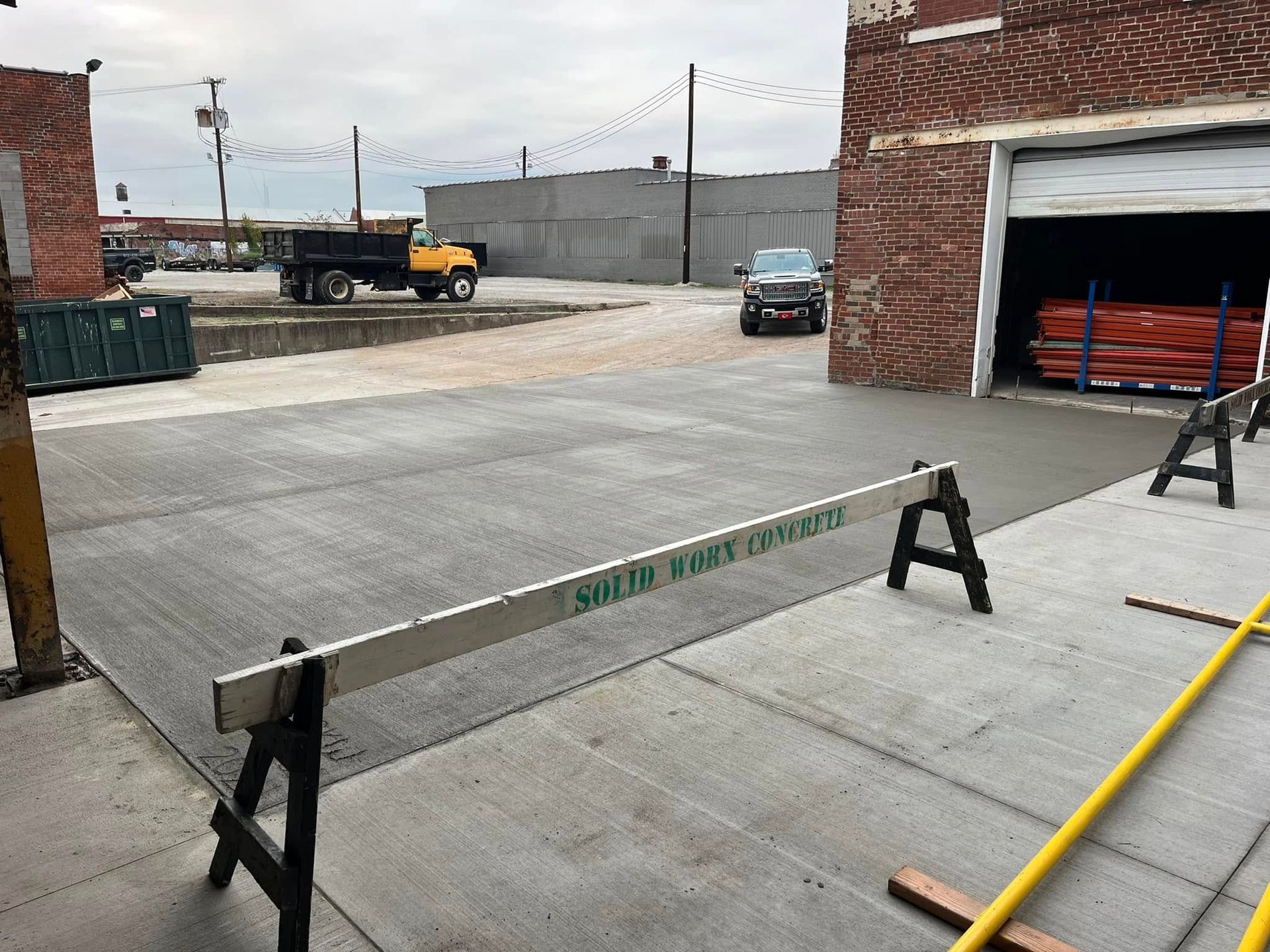 A sidewalk is being built next to a road.