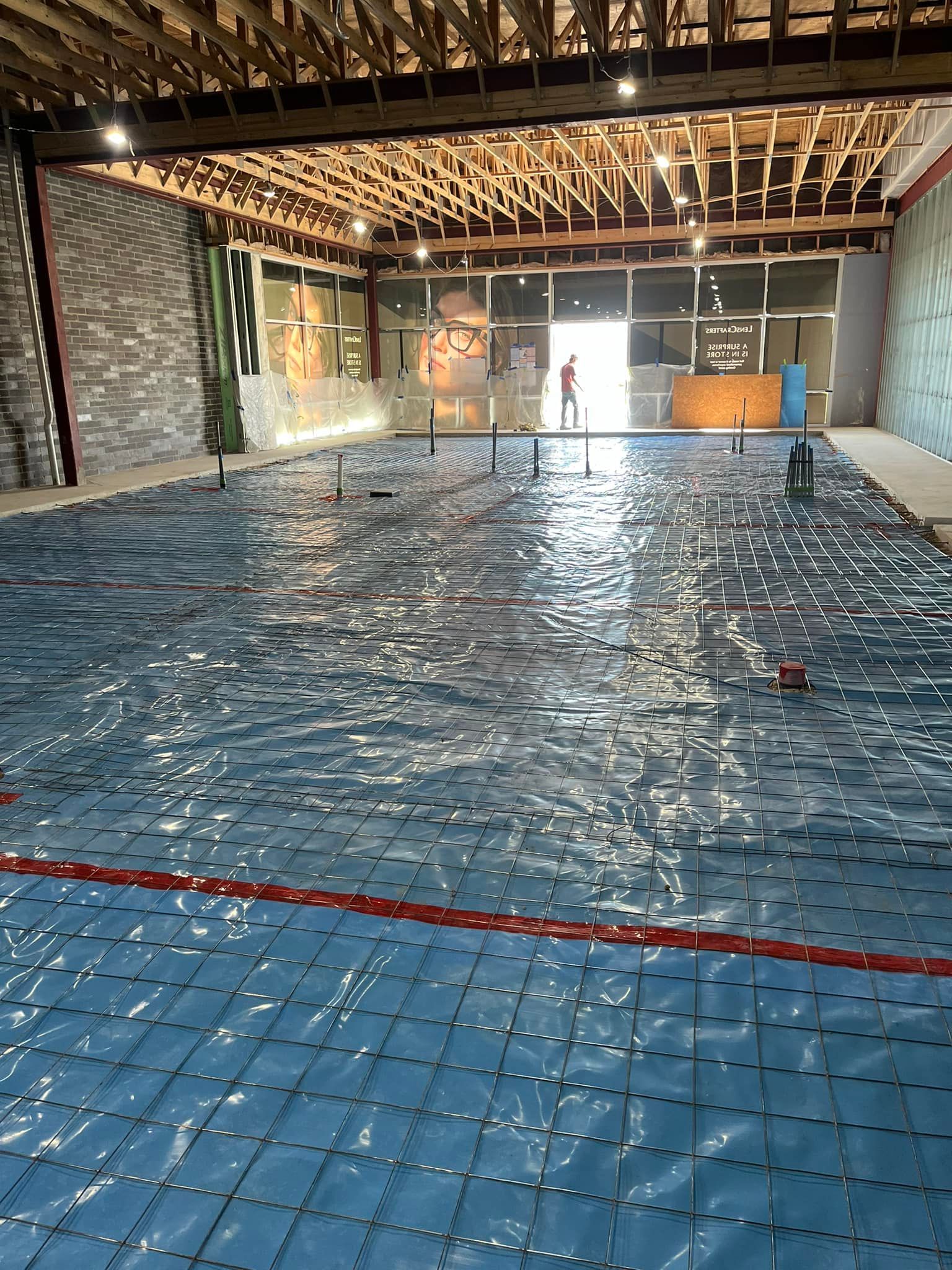 A large indoor swimming pool with blue tiles and a red line.