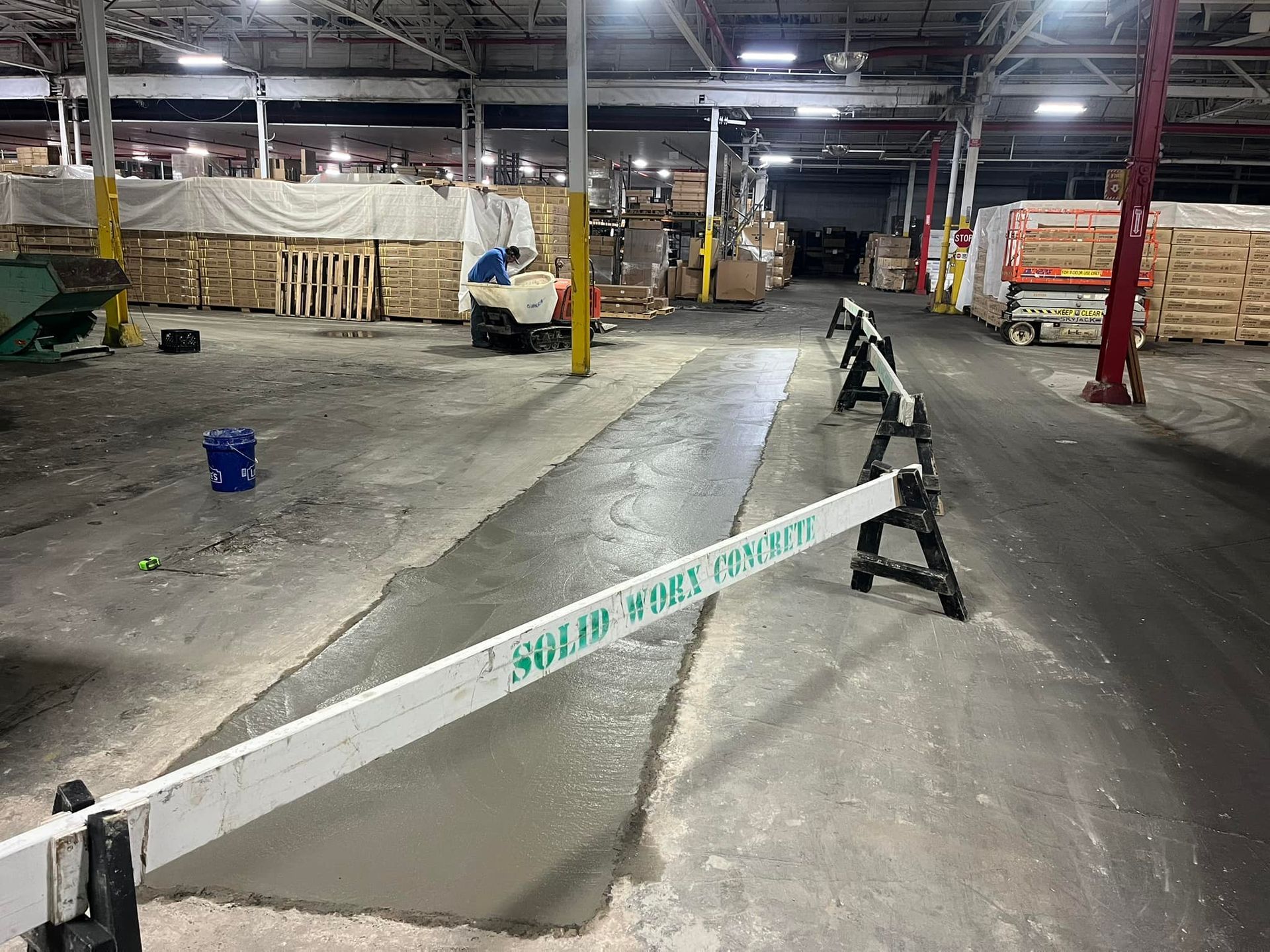 A warehouse with a concrete floor and a concrete barrier.