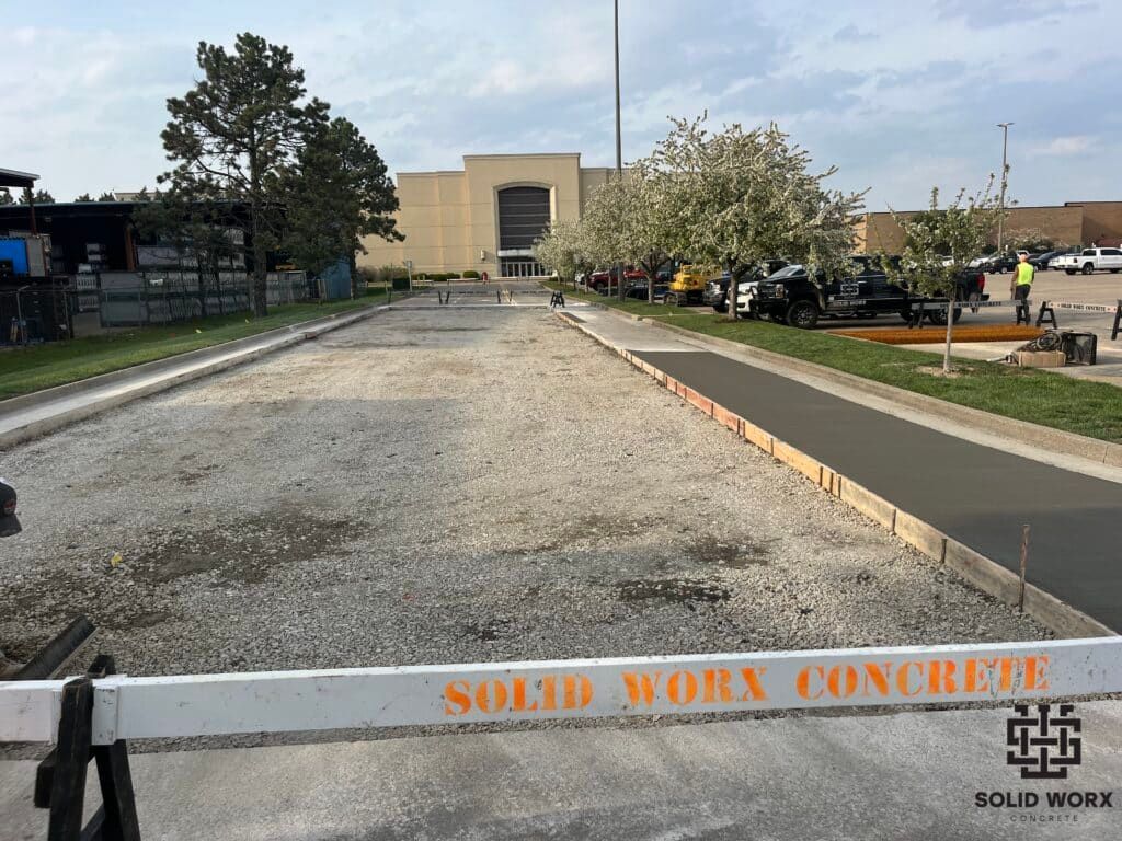 A concrete driveway is being built in front of a building.