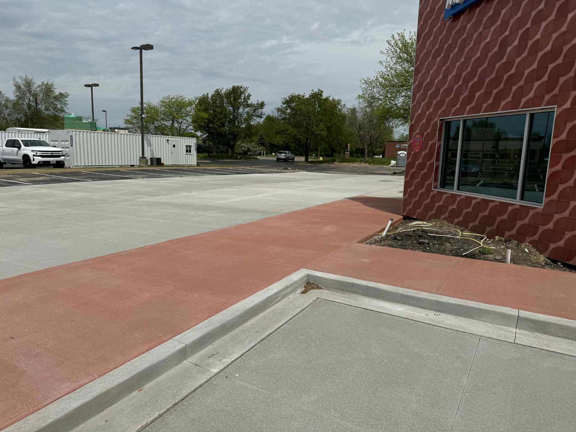 A red building with a white truck parked in front of it