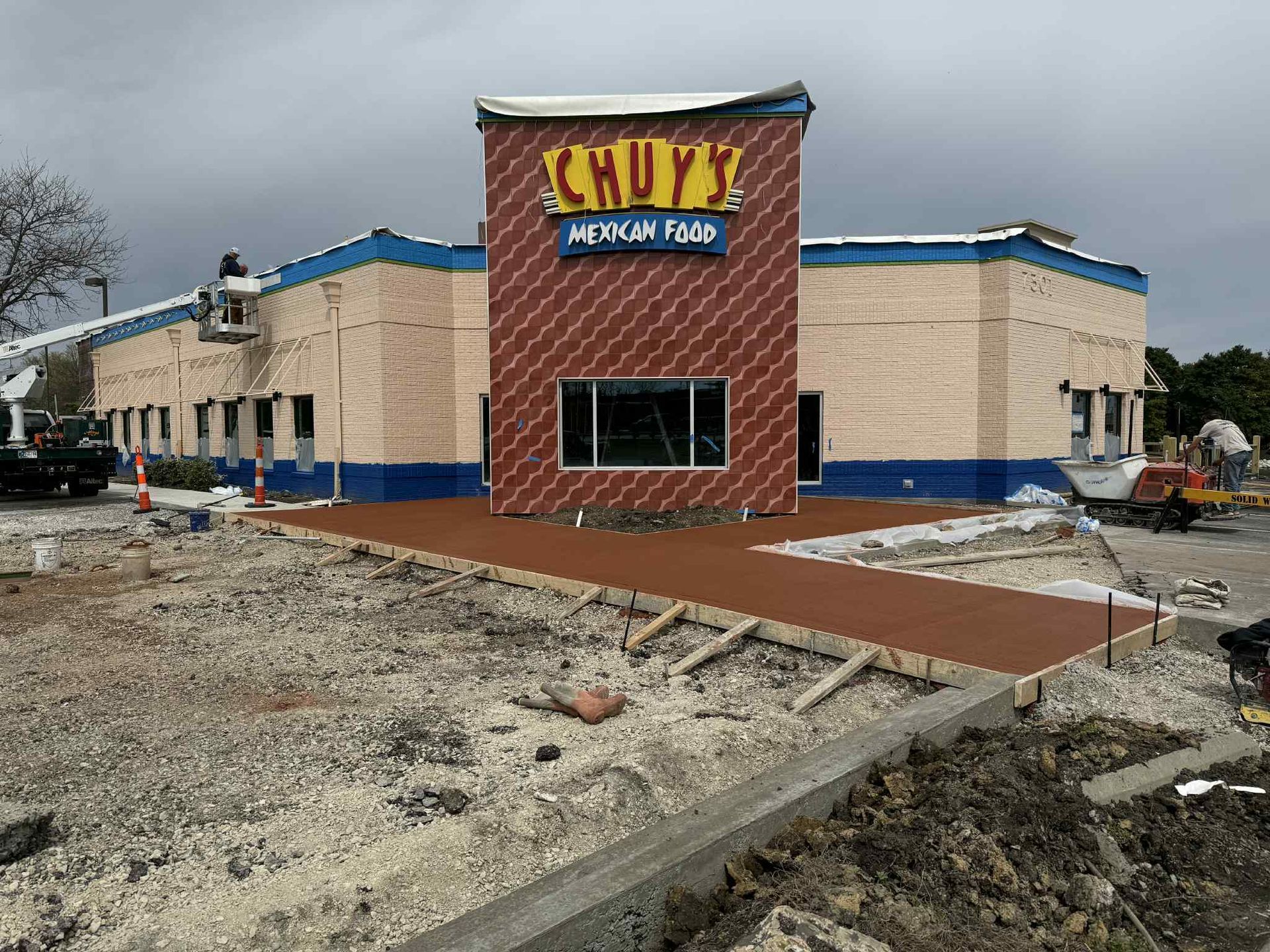 A building that is being built with a lot of dirt in front of it.