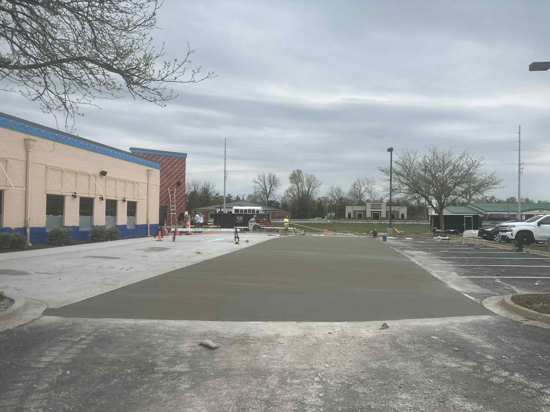 A concrete driveway is being built in front of a building.