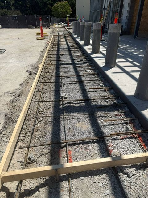 A concrete walkway is being built with a wooden frame