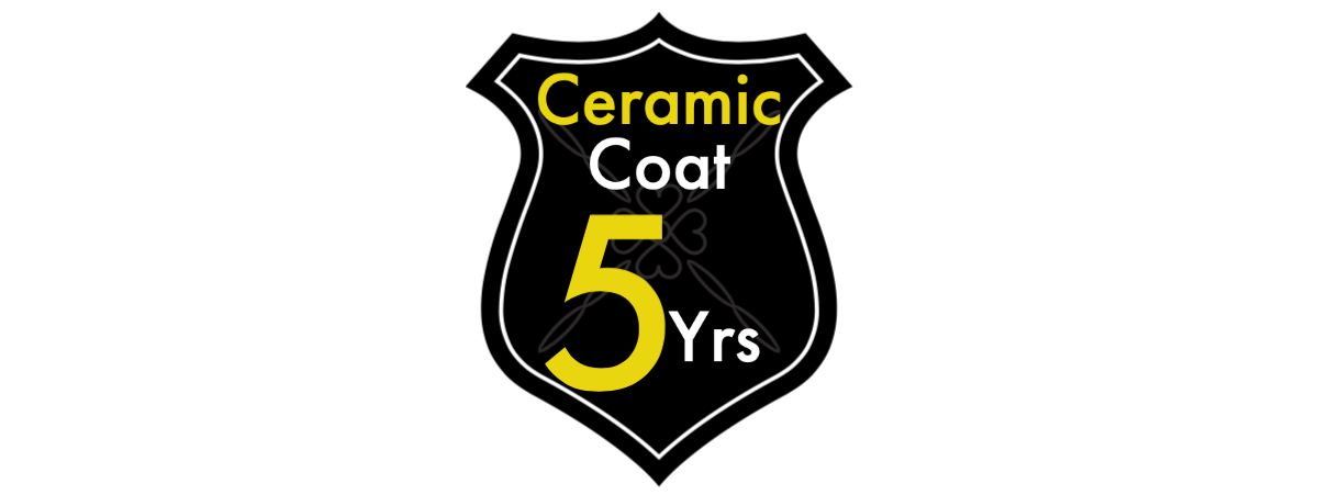 A black and yellow shield with the words `` ceramic coal 5 yrs '' written on it.