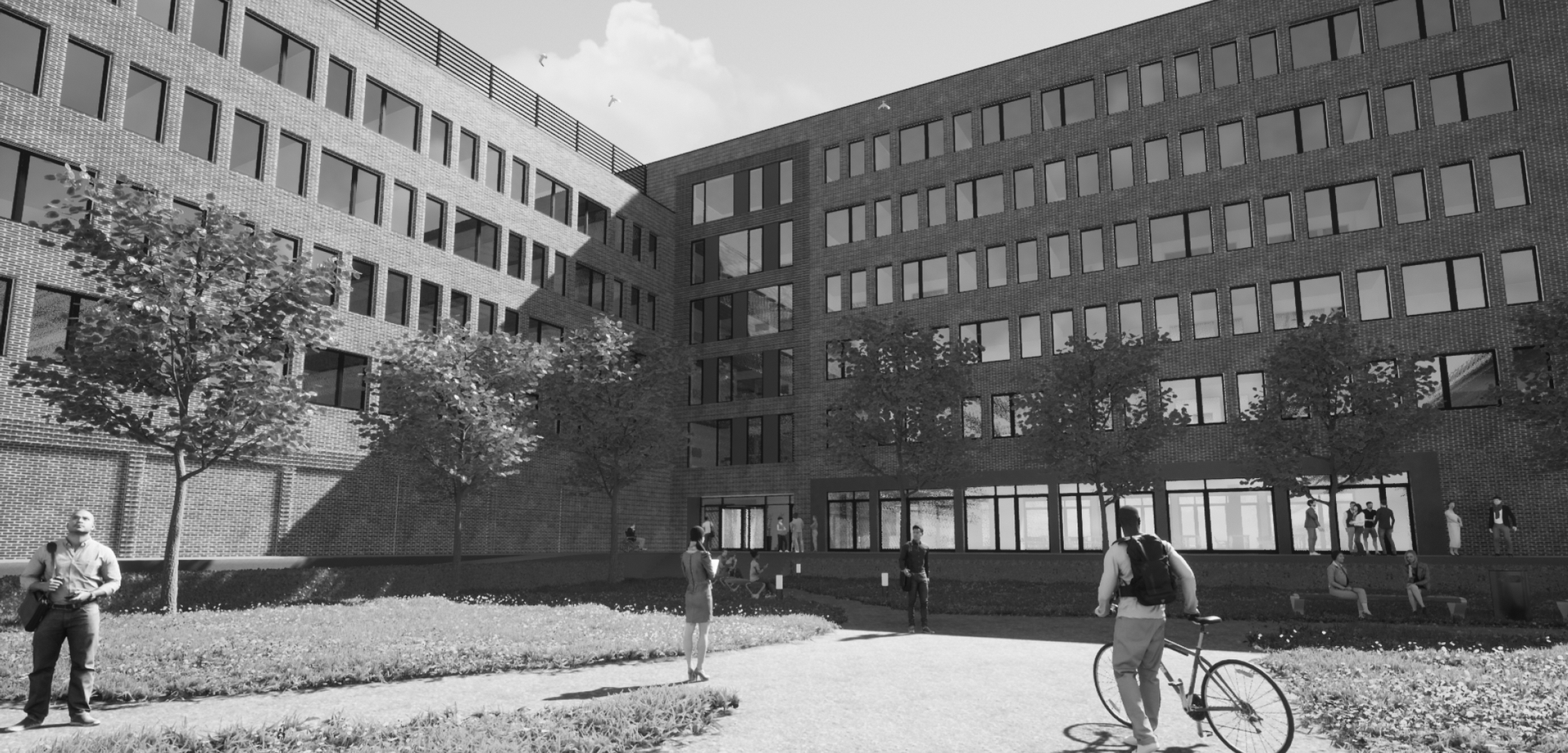 Ein Mann fährt vor einem großen Gebäude Fahrrad.