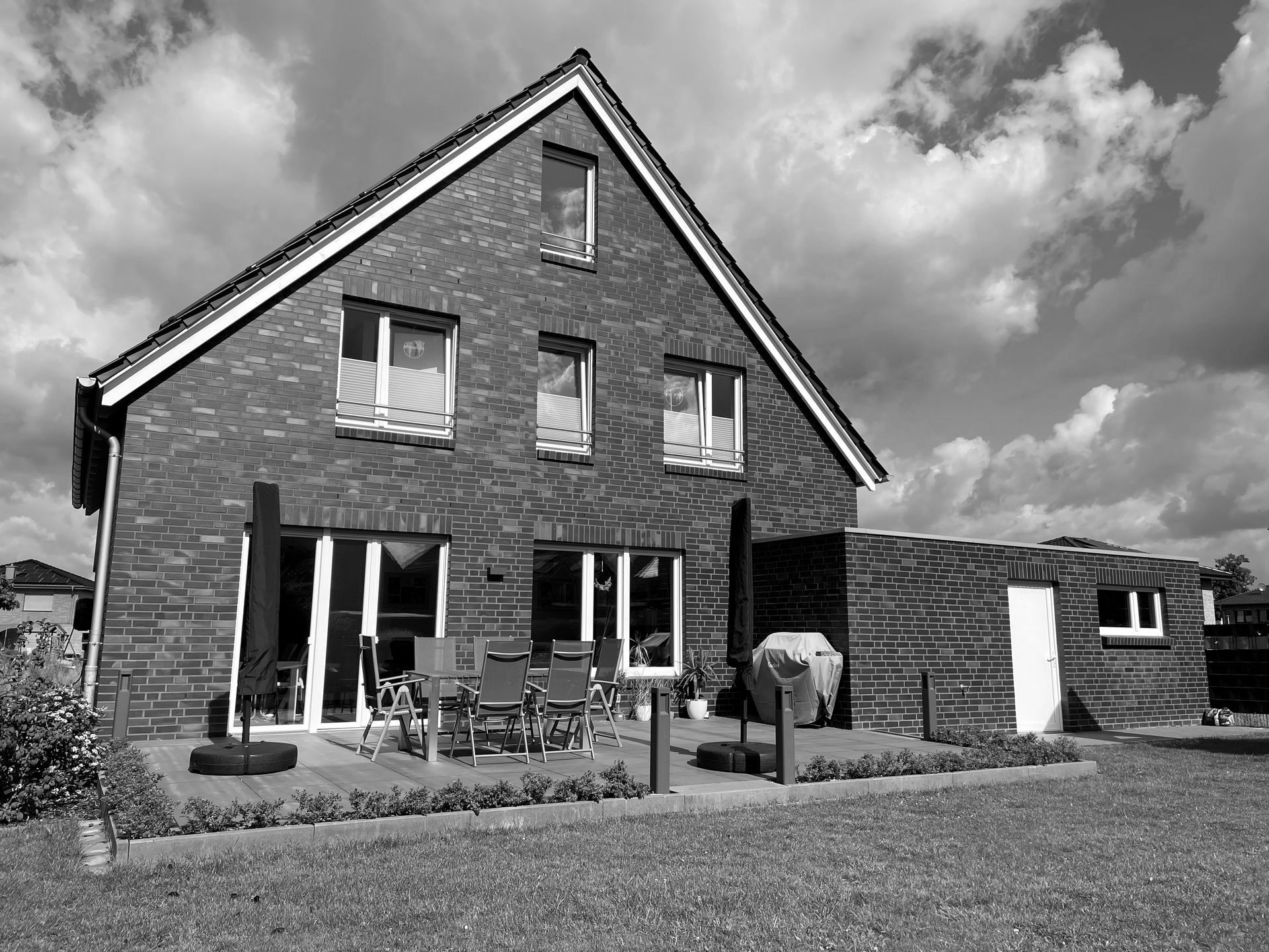 Ein Schwarzweißfoto eines großen Backsteinhauses