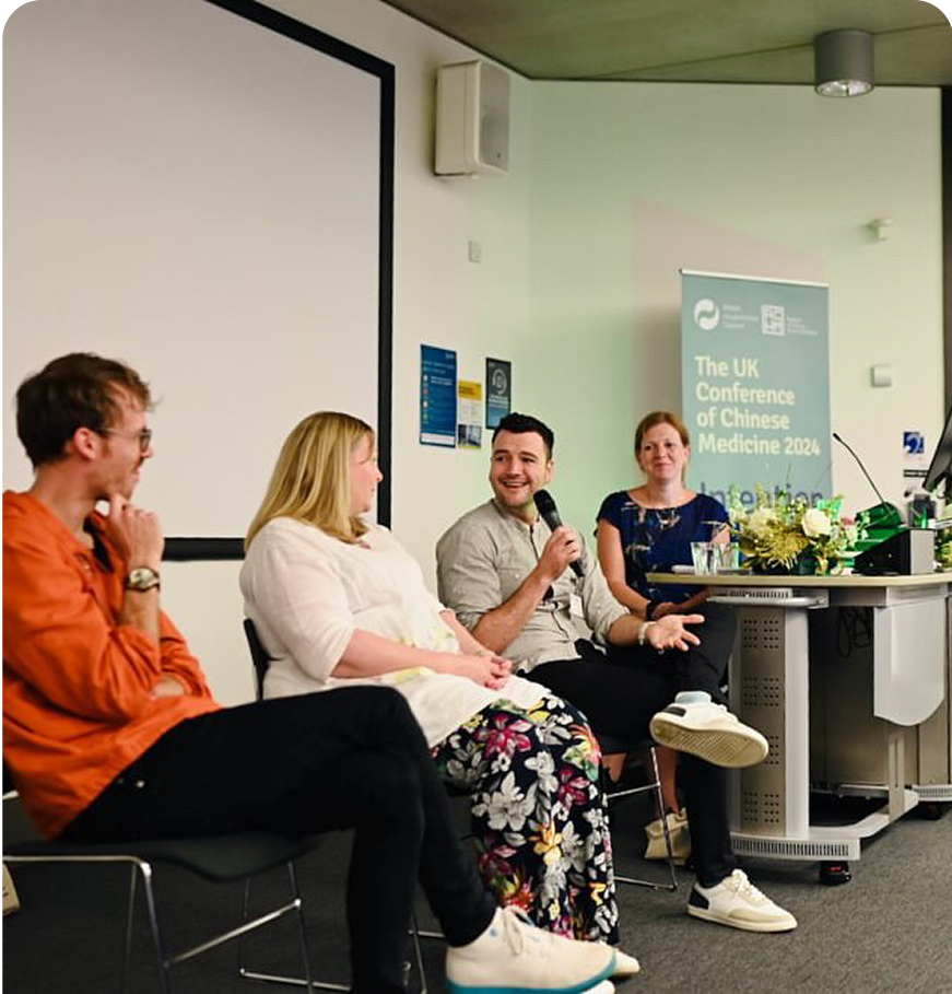 A picture of Josh presenting at the British Acupuncture Council as part of a panel discussion with three other people.