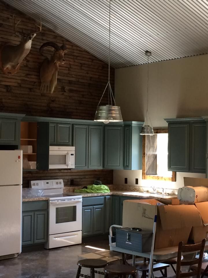 A kitchen with blue cabinets and a white refrigerator