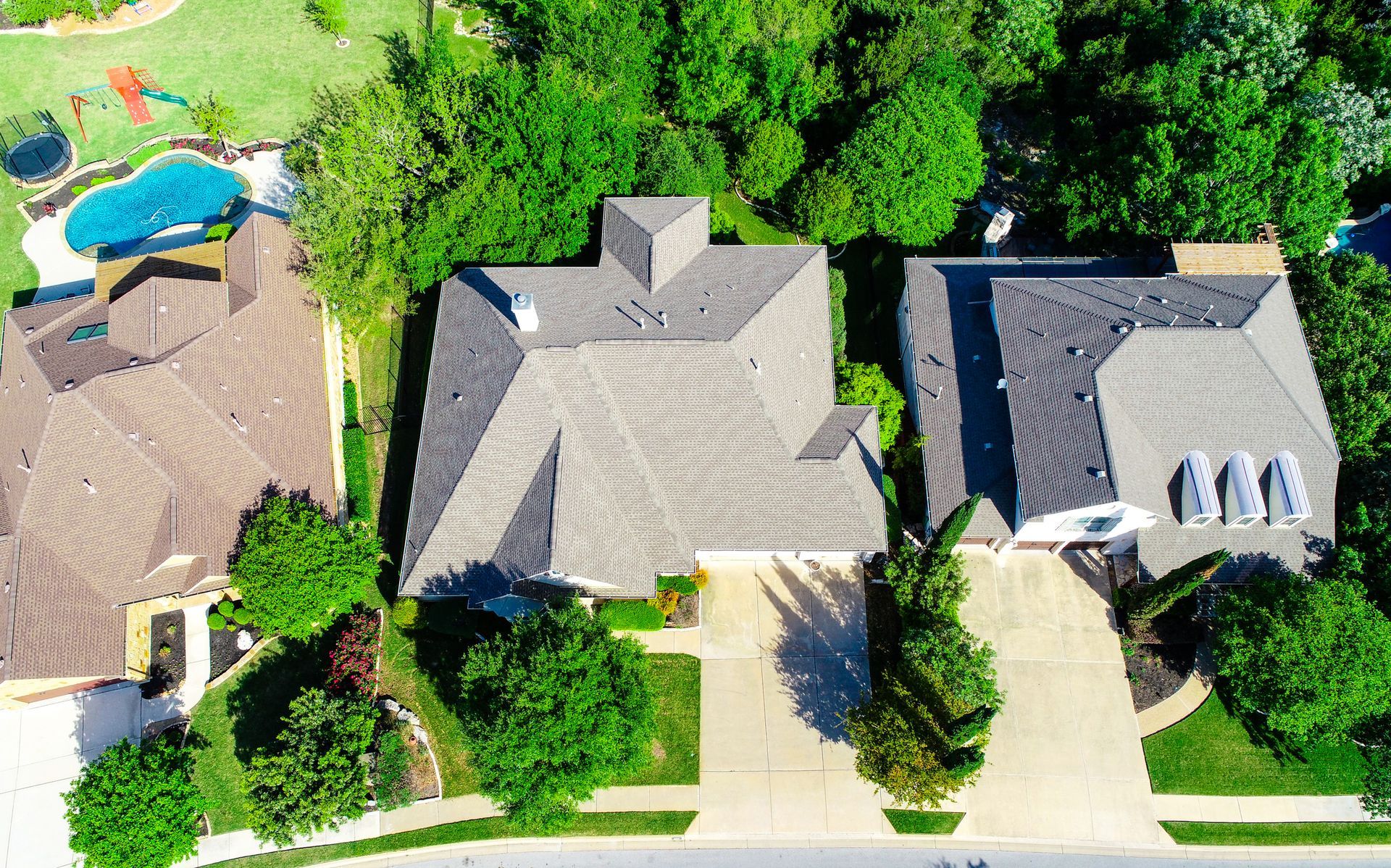 An aerial view of a residential area with houses and trees