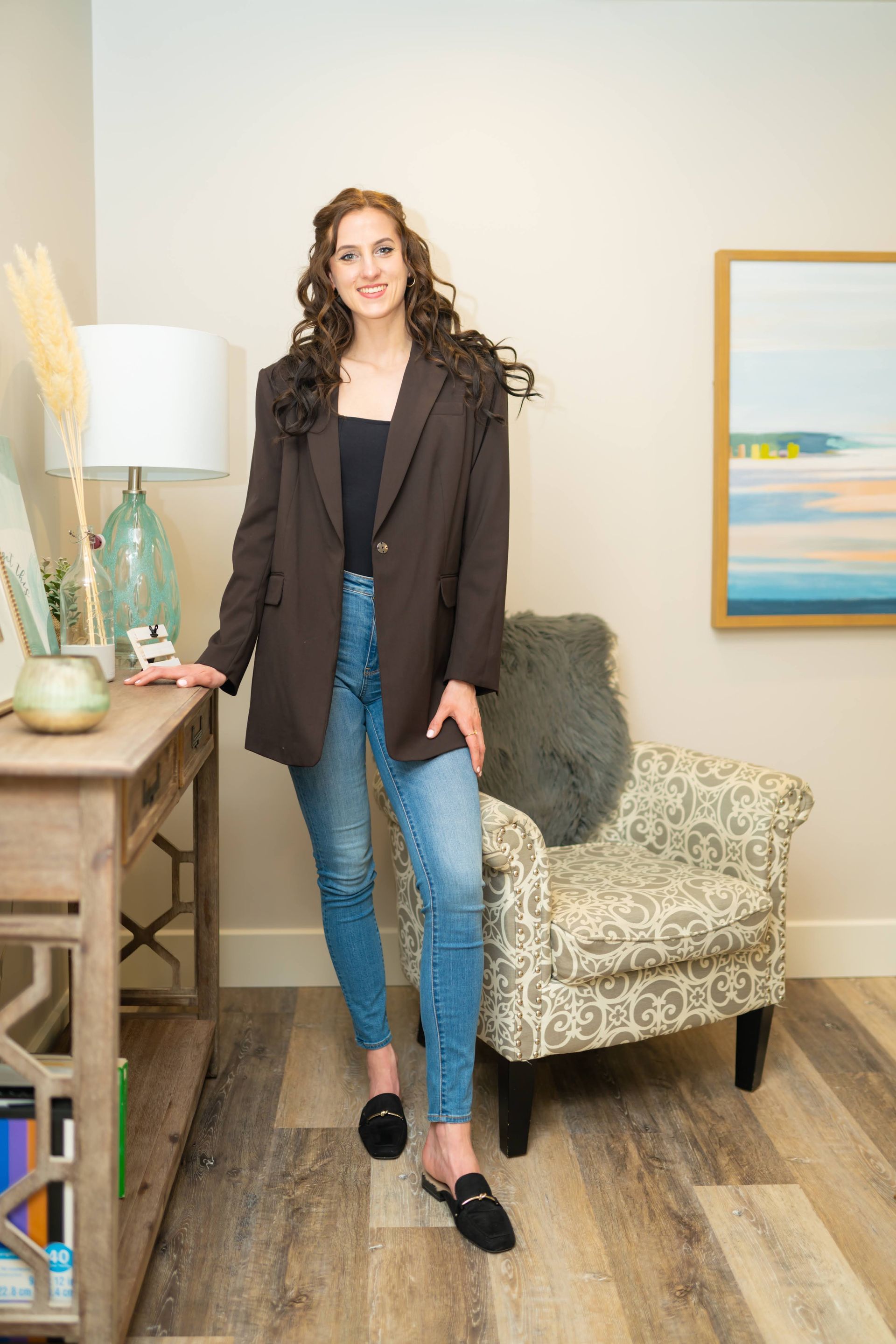 Victoria Jacobs headshot sitting on brown chair