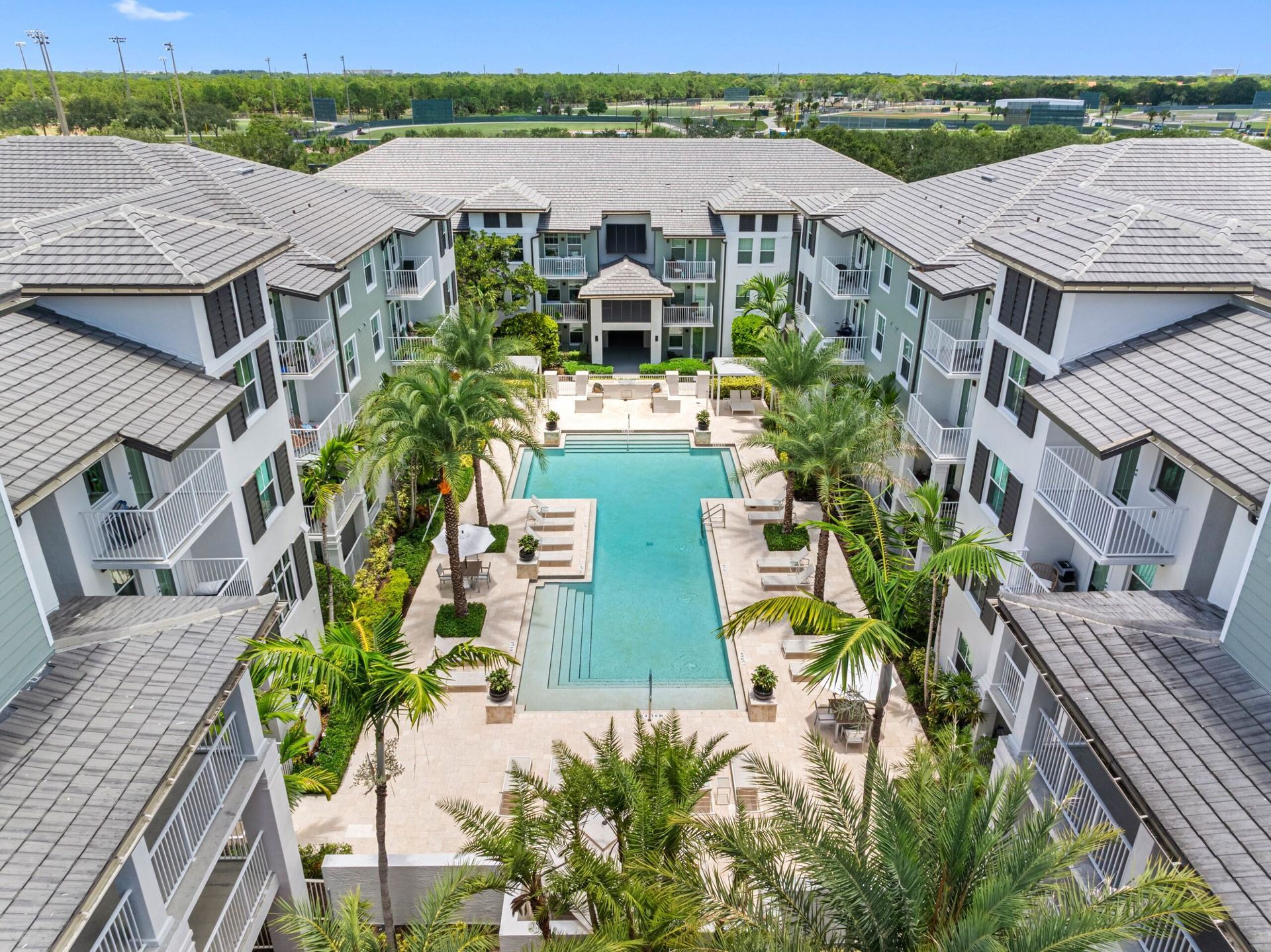 There is a fire pit in the middle of the courtyard of a building.