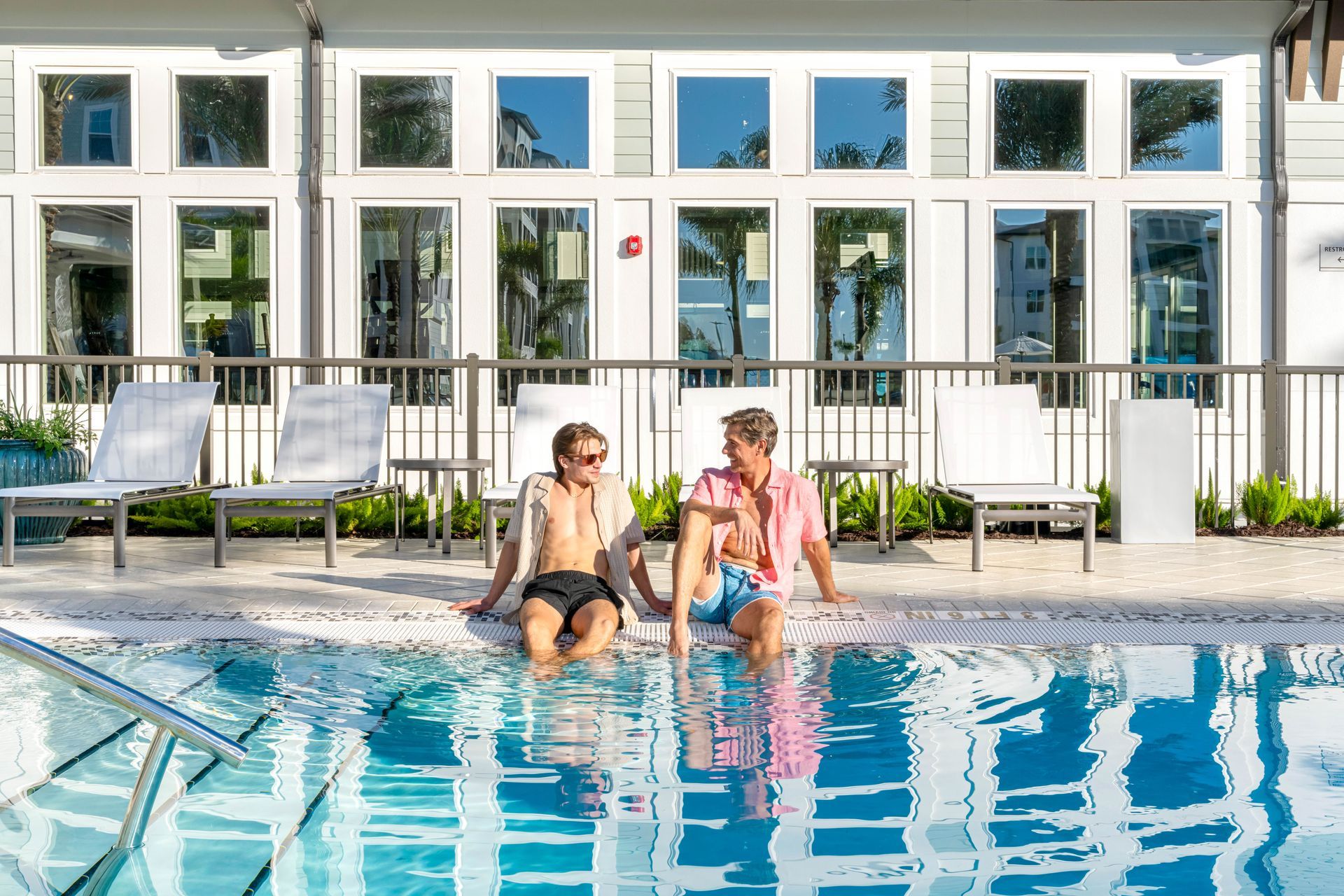 two men at resort style pool,