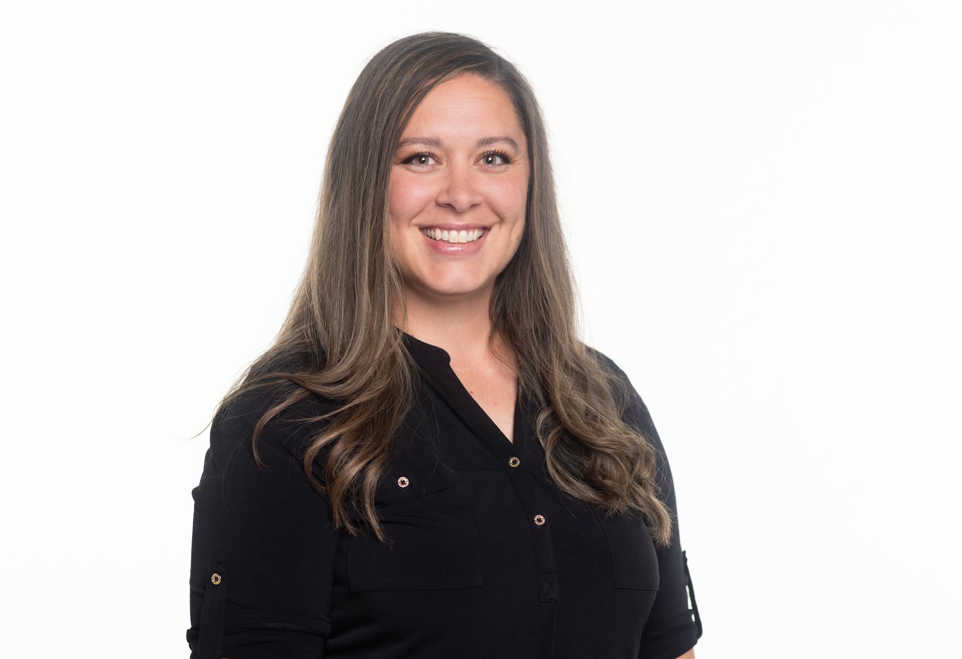 A man in a blue jacket and plaid shirt is smiling for the camera.