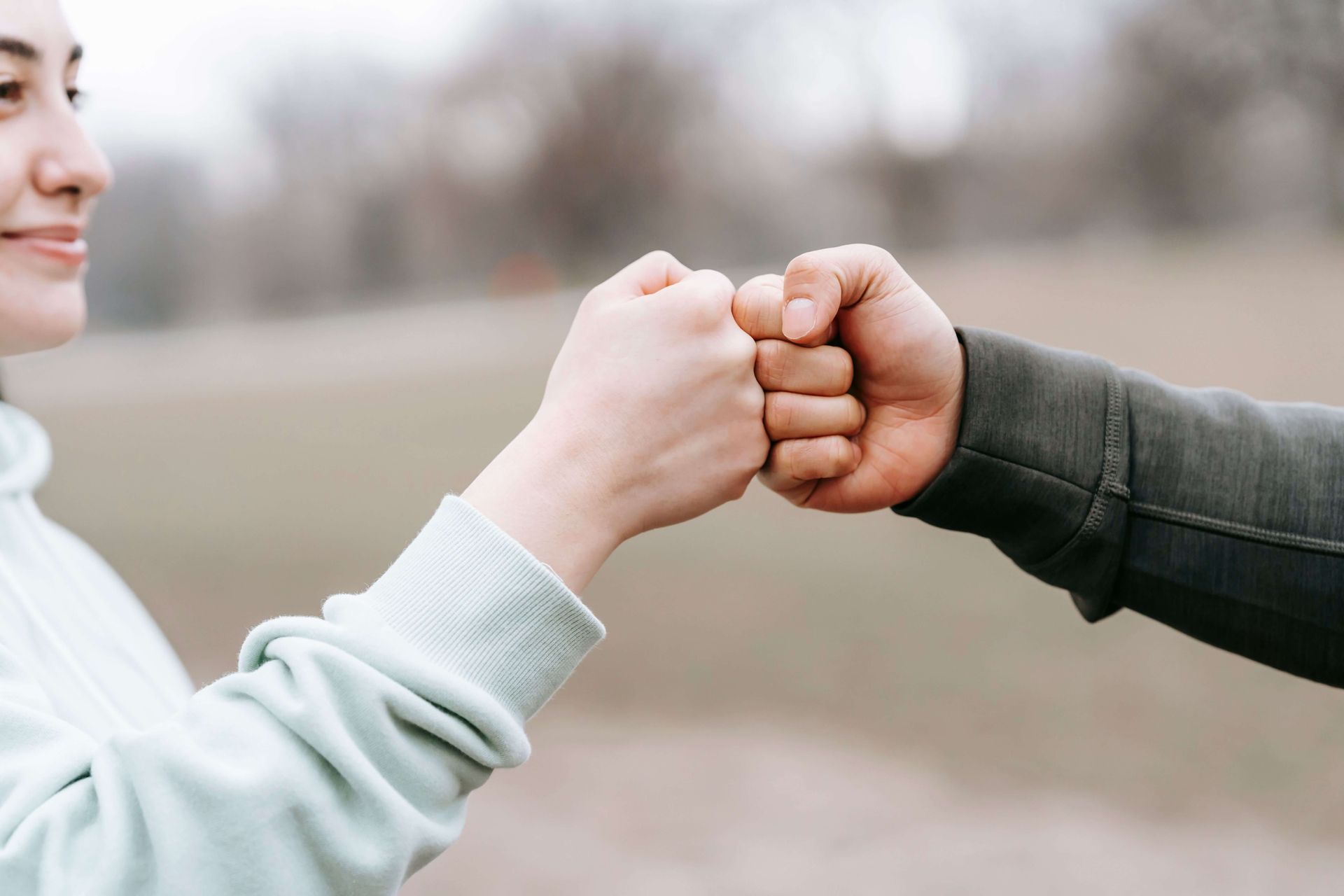 Close-up of two people fist bumping, representing confidence, connection, and positive growth through anxiety therapy in Omaha, NE | anxiety therapy omaha ne - anxiety counseling omaha ne - anxiety therapist omaha ne - elkhorn - gretna - bennington - blair - millard - wahoo - waverly - papillion